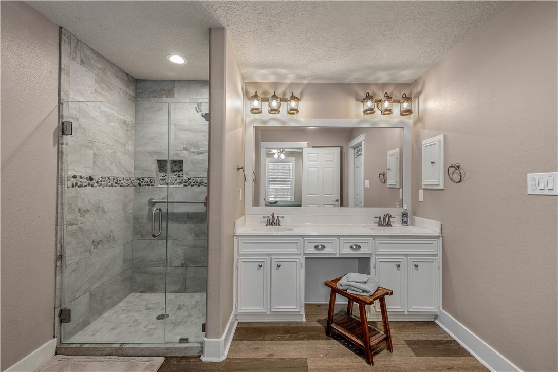 6045 Old Reliance Road Bryan, TX 77808 - Photo 27 of 50 a spacious bathroom with a shower a sink and a mirror