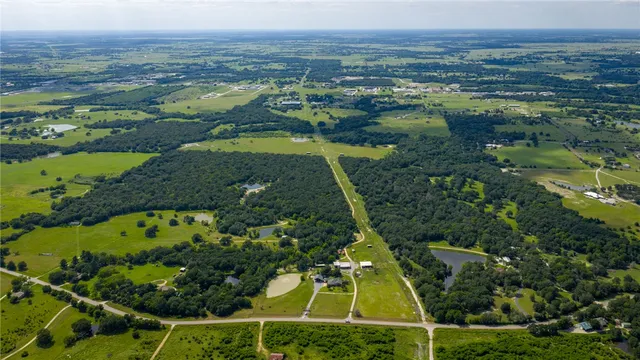 an aerial view of a residential houses with outdoor space