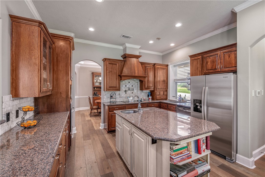 6045 Old Reliance Road Bryan, TX 77808 - Photo 10 of 50 a kitchen with stainless steel appliances granite countertop a sink refrigerator and cabinets