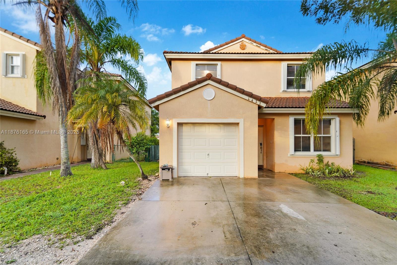 1433 Southeast 20th Road Homestead, FL 33035 - Photo 2 of 19 a front view of a house with a yard and garage