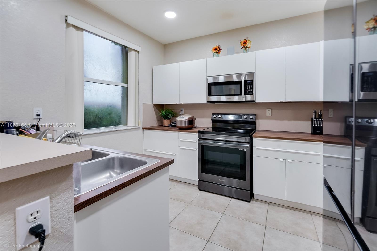 1433 Southeast 20th Road Homestead, FL 33035 - Photo 10 of 19 a kitchen with stainless steel appliances granite countertop a sink and a stove