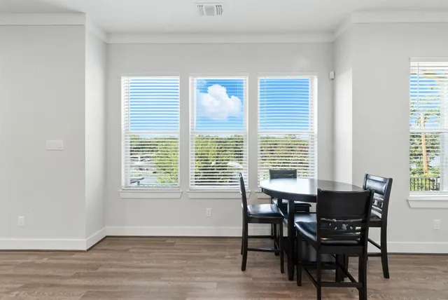 a view of a dining room with furniture and windows