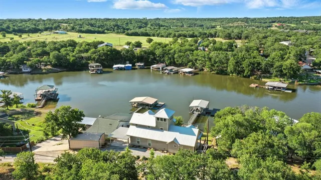 an aerial view of a house with a lake view