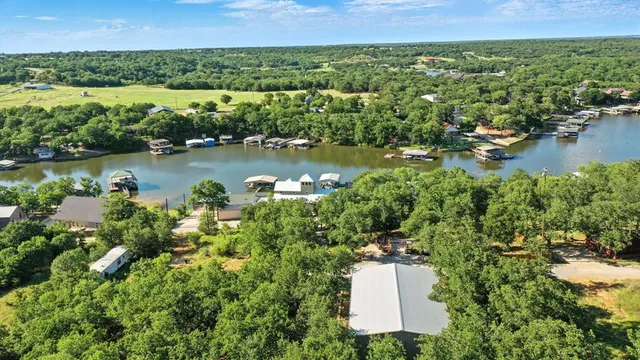 an aerial view of a house with a lake view