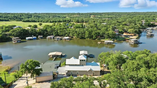 an aerial view of a house with a lake view