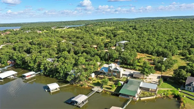 an aerial view of a houses with a yard