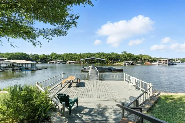 a view of a lake with houses in back