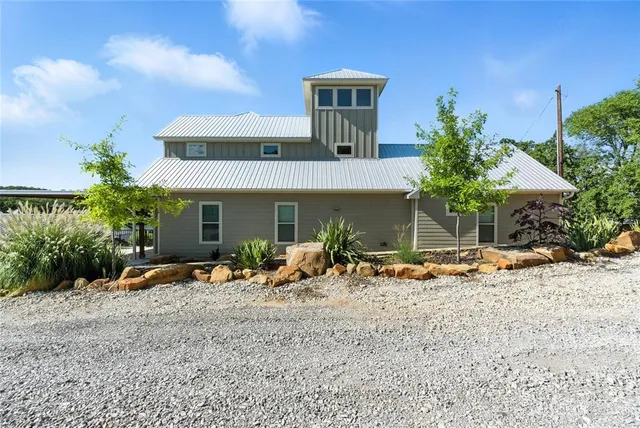 a view of a house with backyard and sitting area