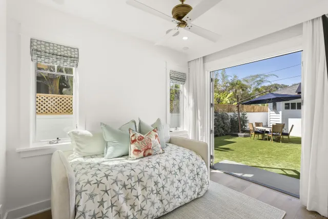 a bedroom with furniture and a large window