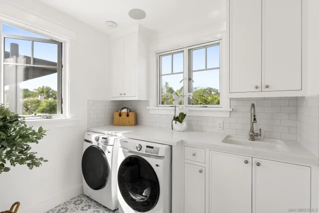 a kitchen with a white cabinets and window