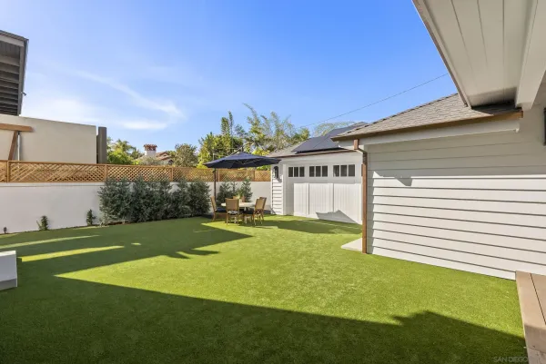 a patio with a table and chairs