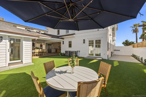 a view of a backyard with sitting area