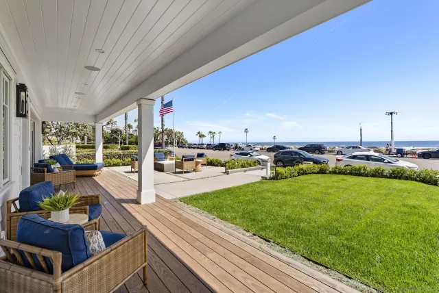 a view of house with yard and sitting area