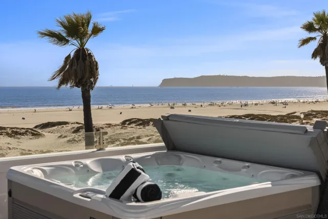 a kitchen with a sink and a cabinet with an ocean view