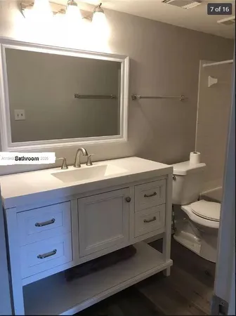 a bathroom with a sink a toilet and mirror