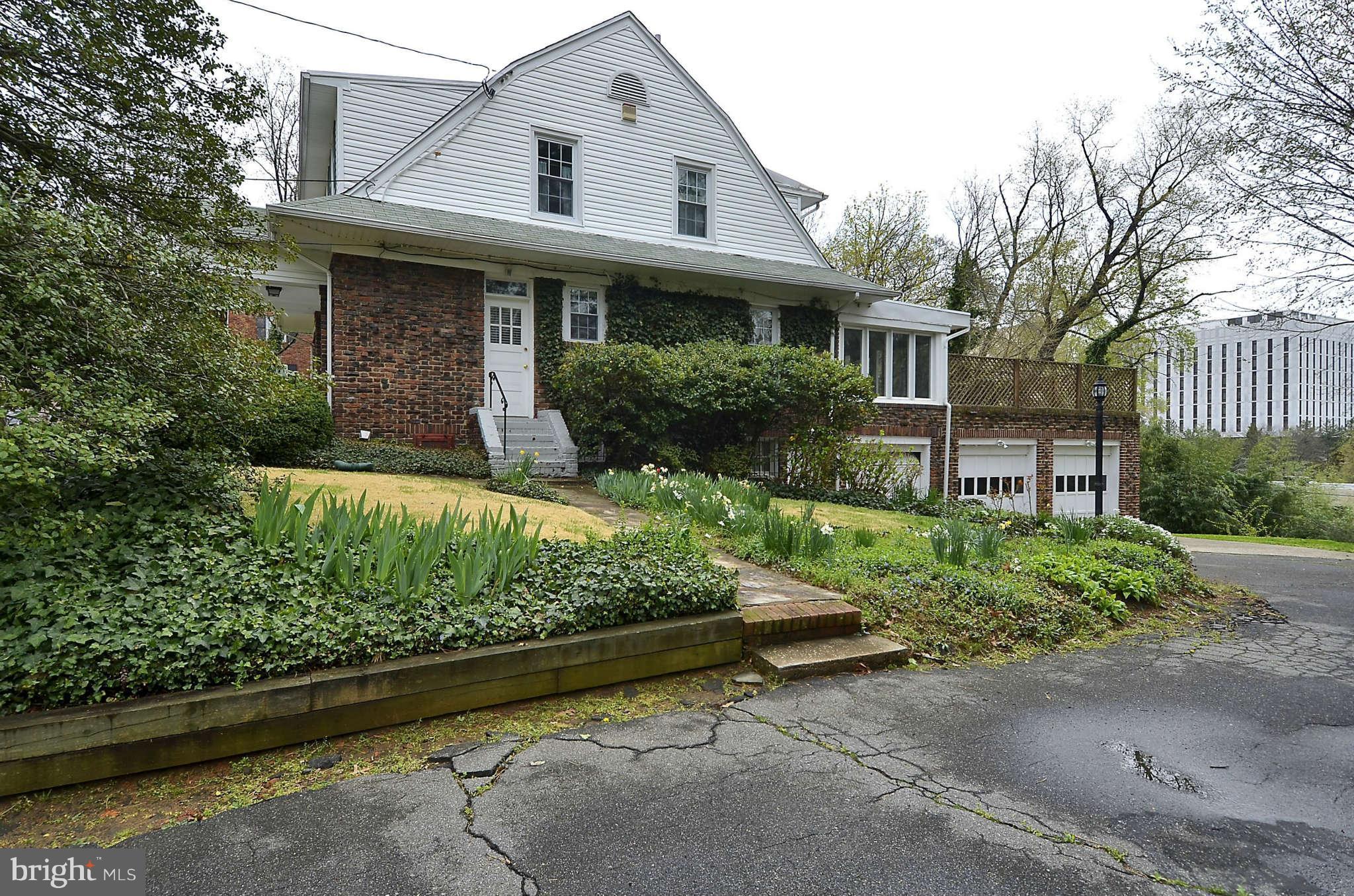 3814 Fulton Street Northwest Washington, DC 20007 - Photo 2 of 18 a front view of a house with a garden and plants