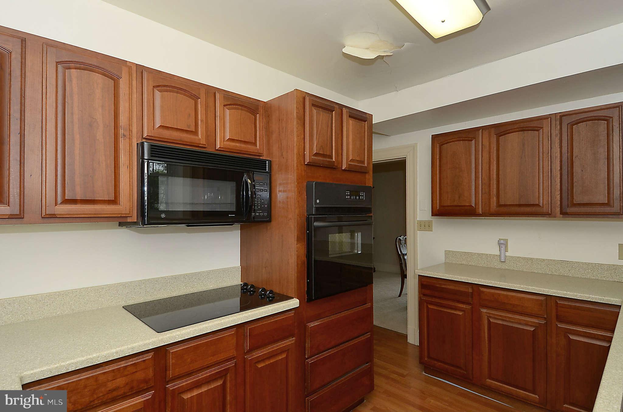 3814 Fulton Street Northwest Washington, DC 20007 - Photo 5 of 18 a kitchen with granite countertop wooden cabinets and stainless steel appliances