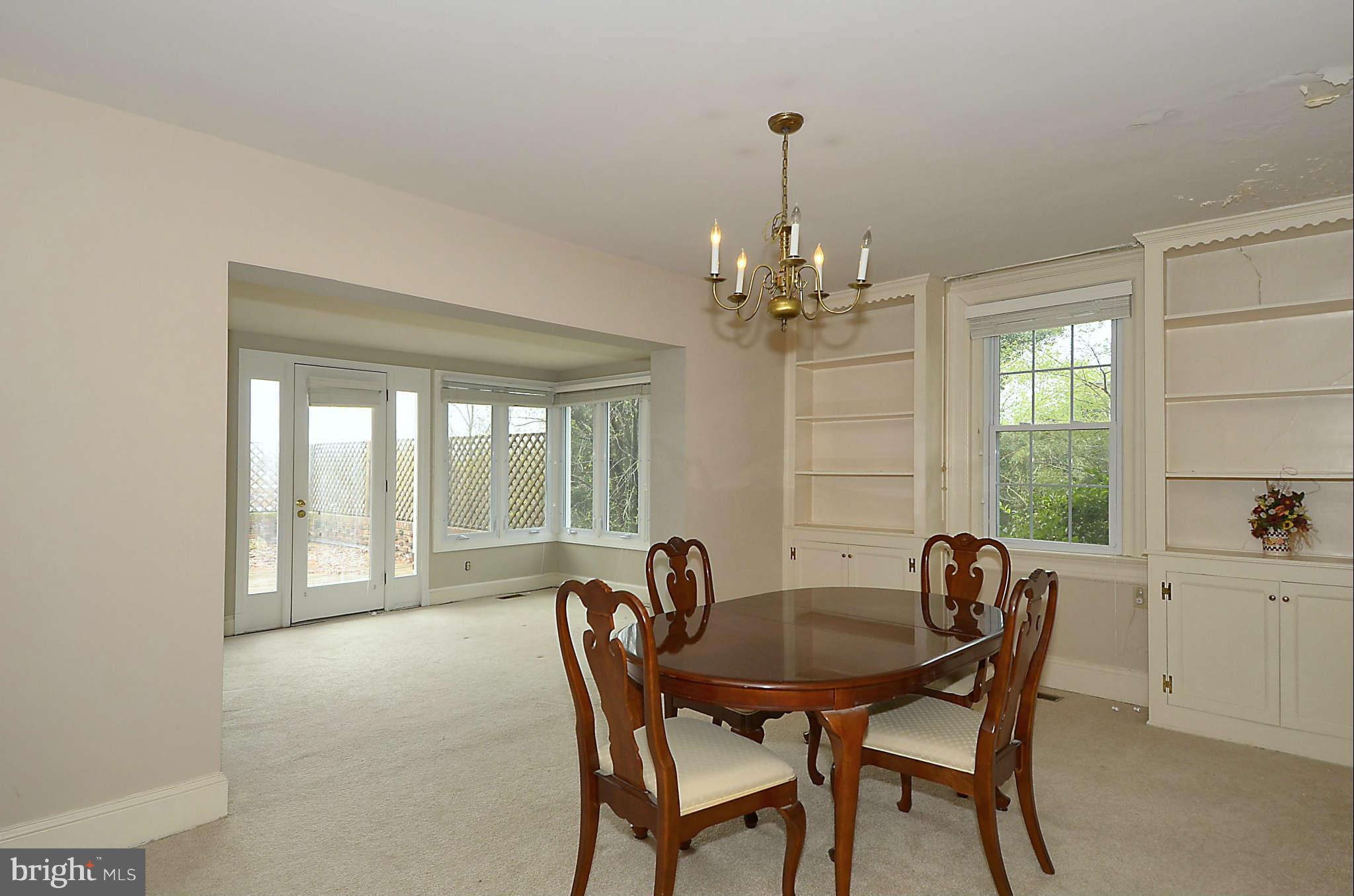 3814 Fulton Street Northwest Washington, DC 20007 - Photo 6 of 18 a view of a dining room with furniture a chandelier and wooden floor