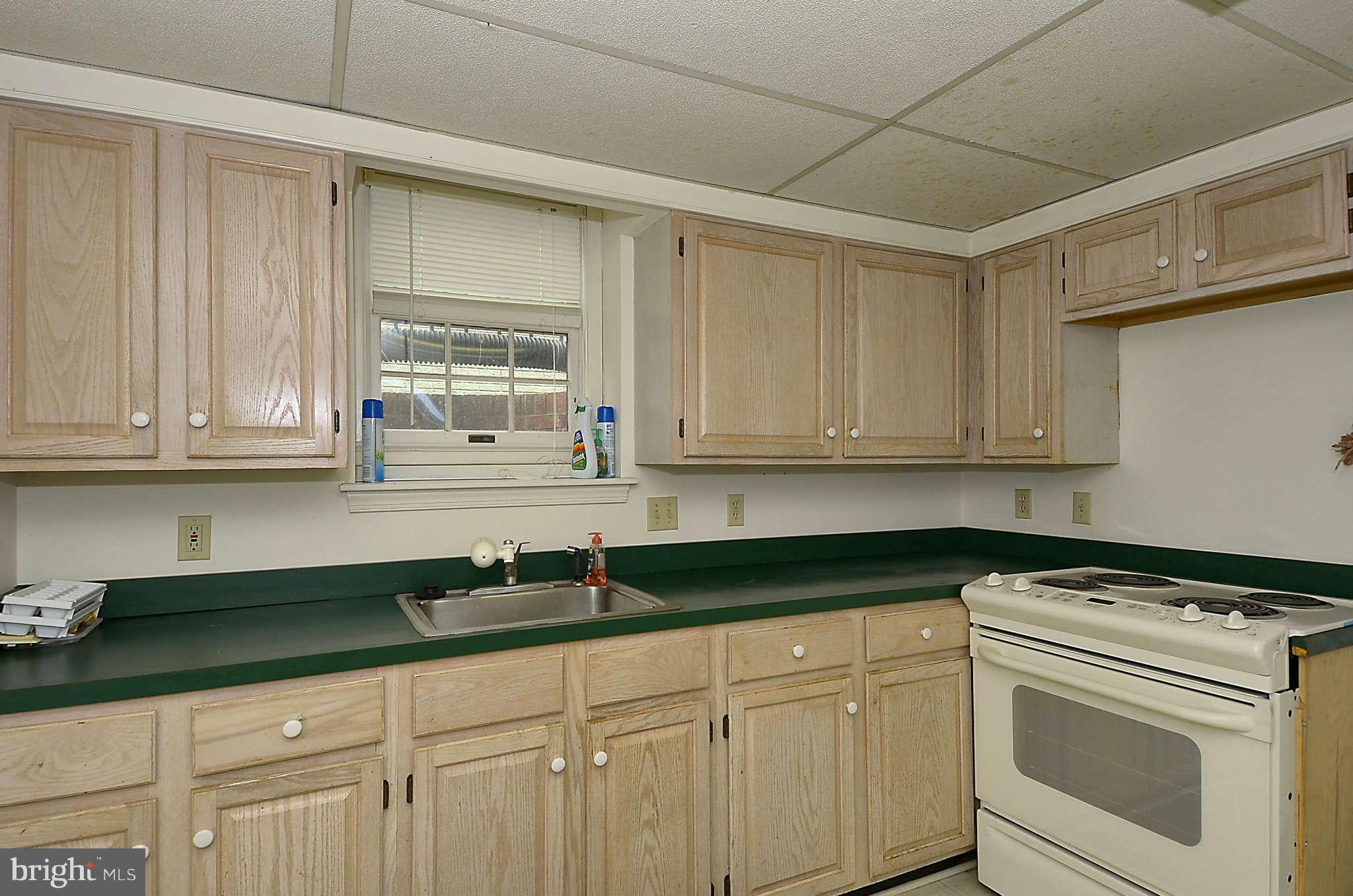 3814 Fulton Street Northwest Washington, DC 20007 - Photo 10 of 18 a kitchen with granite countertop white cabinets and white appliances
