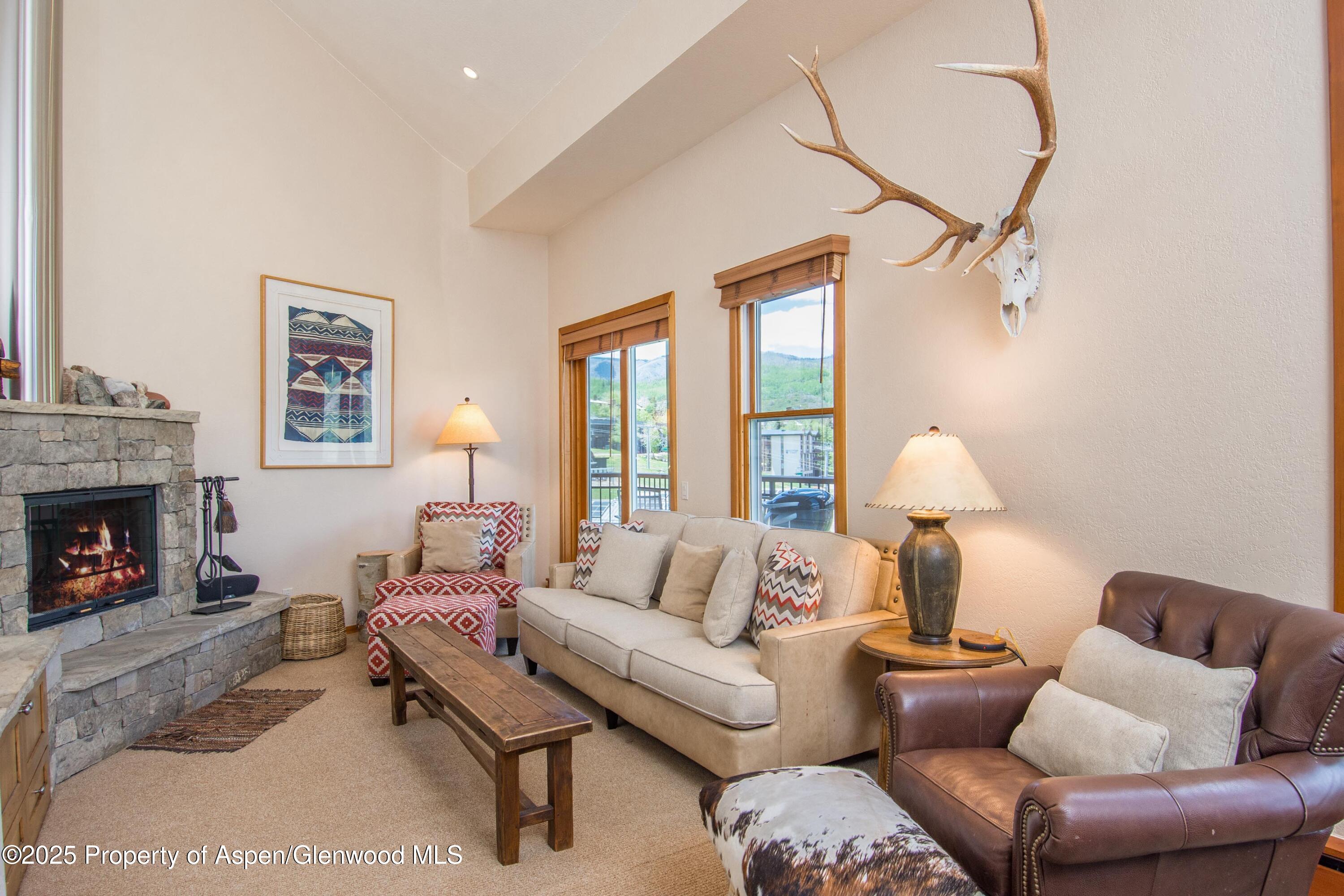 425 Wood Road, Unit 48 Snowmass Village, CO 81615 - Photo 5 of 41 a living room with furniture and a fireplace