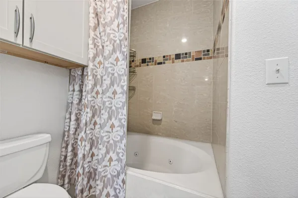 a bathroom with a bathtub and shower