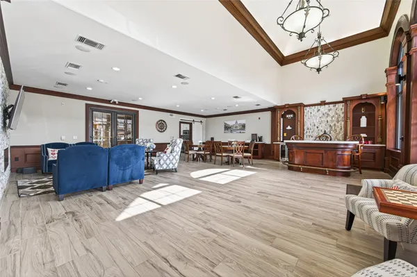 a living room with lots of furniture and a wooden floor