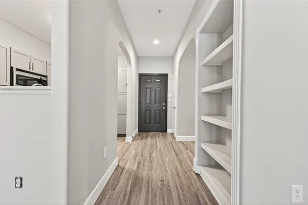 a view of gallery with wooden floor