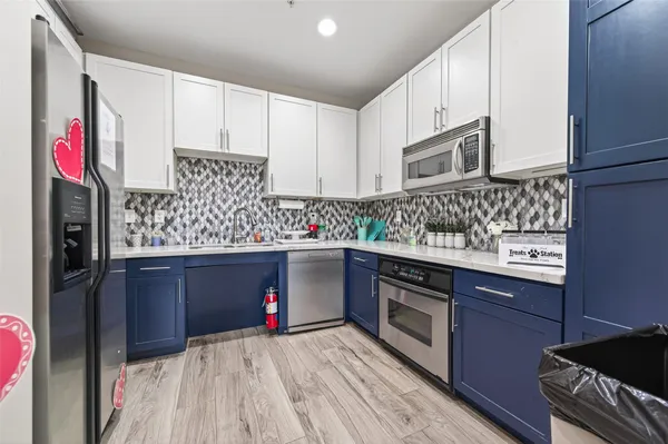 a kitchen with stainless steel appliances granite countertop a stove and cabinets