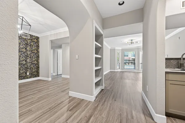 a view of livingroom with hardwood floor and a kitchen