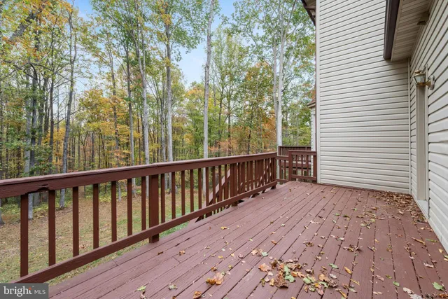 a view of a balcony with wooden floor and fence