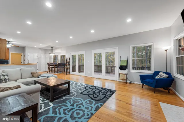 a living room with furniture and floor to ceiling window