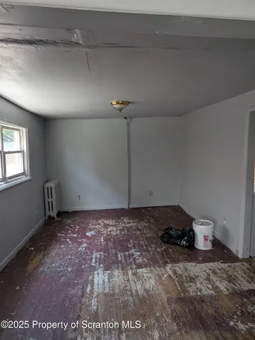 a view of a room with an empty space and a window