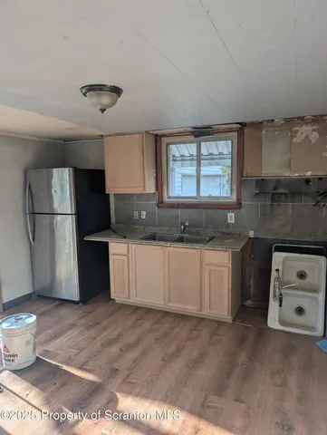 a kitchen with a refrigerator and a sink