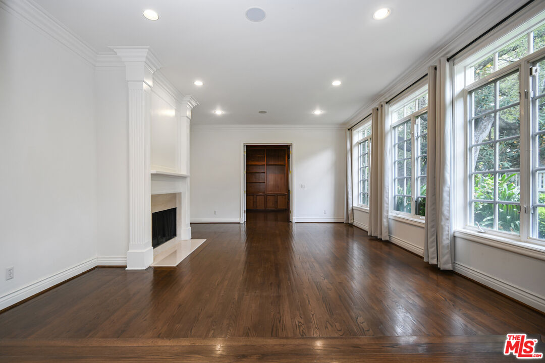 3254 Oakdell Road Studio City, CA 91604 - Photo 11 of 49 a view of empty room with wooden floor and fireplace