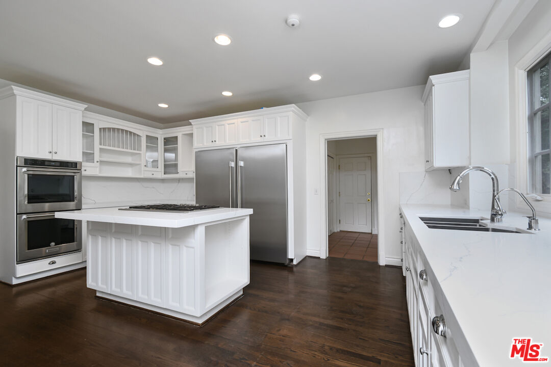 3254 Oakdell Road Studio City, CA 91604 - Photo 22 of 49 a kitchen with kitchen island a sink stainless steel appliances and cabinets