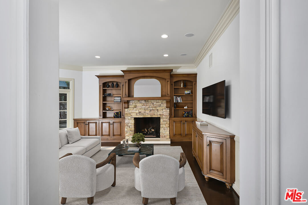 3254 Oakdell Road Studio City, CA 91604 - Photo 29 of 49 a living room with furniture a fireplace and a flat screen tv