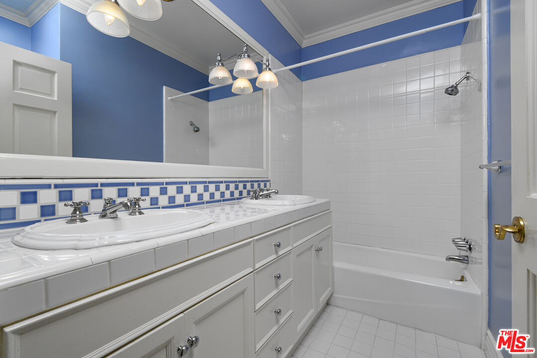 3254 Oakdell Road Studio City, CA 91604 - Photo 34 of 49 a bathroom with a sink a mirror and a bathtub