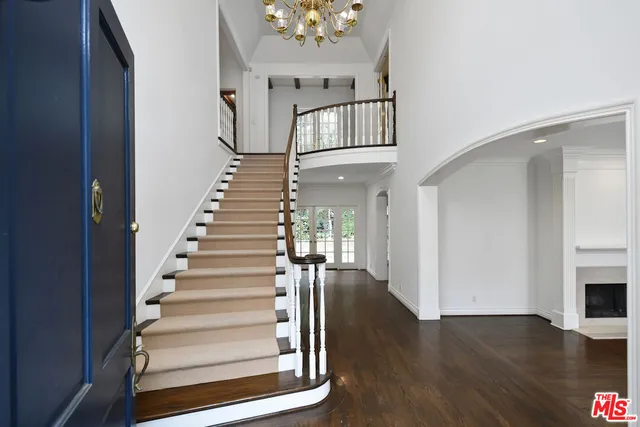 a view of empty room with wooden floor and fireplace