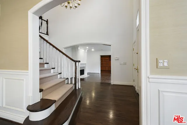 a living room with fireplace furniture and a wooden floor