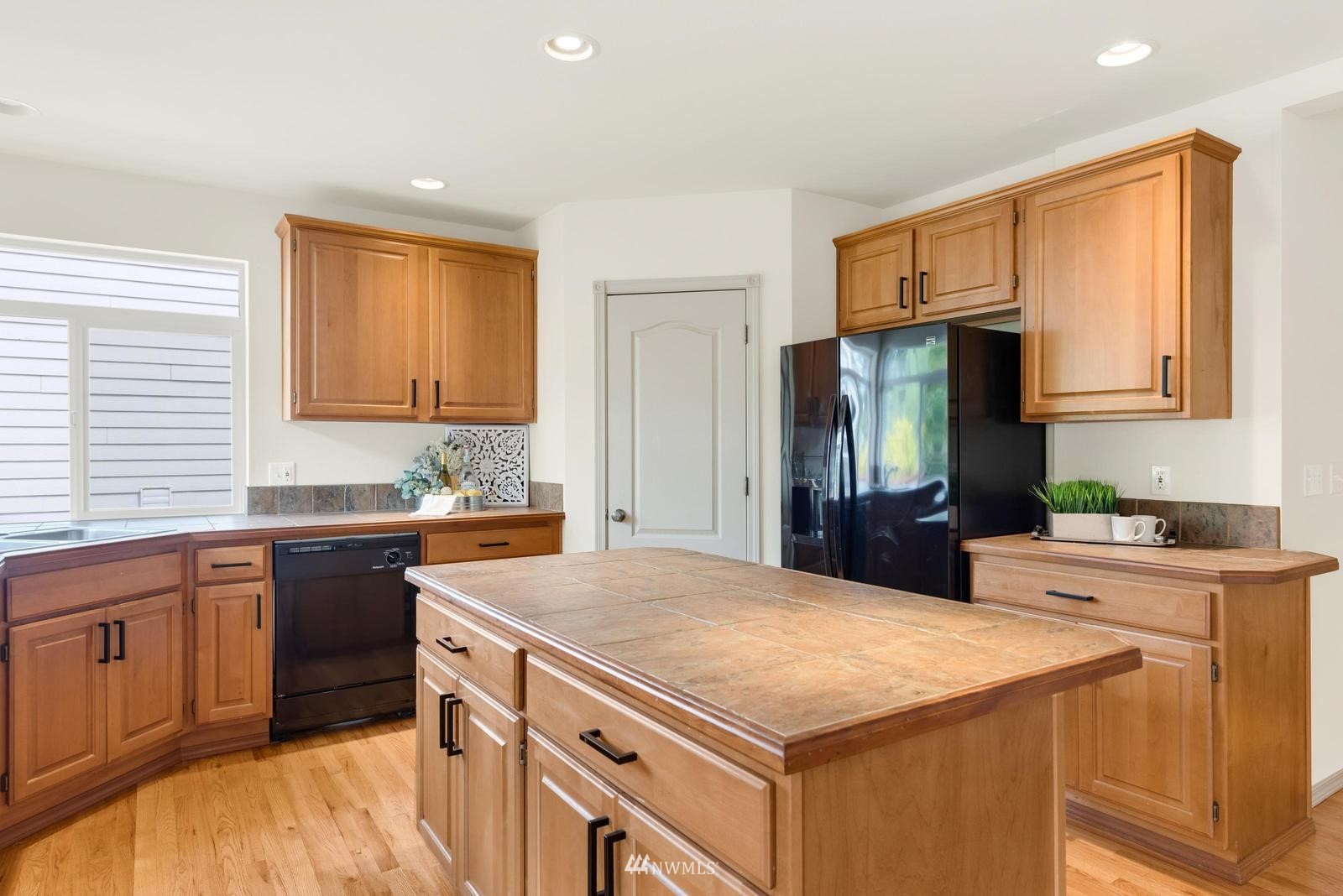 16218 Southeast 249th Place Covington, WA 98042 - Photo 14 of 38 a kitchen with a stove a sink and a refrigerator