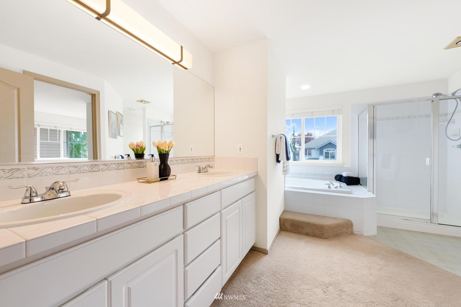 16218 Southeast 249th Place Covington, WA 98042 - Photo 29 of 38 a spacious bathroom with a tub double sink and mirror