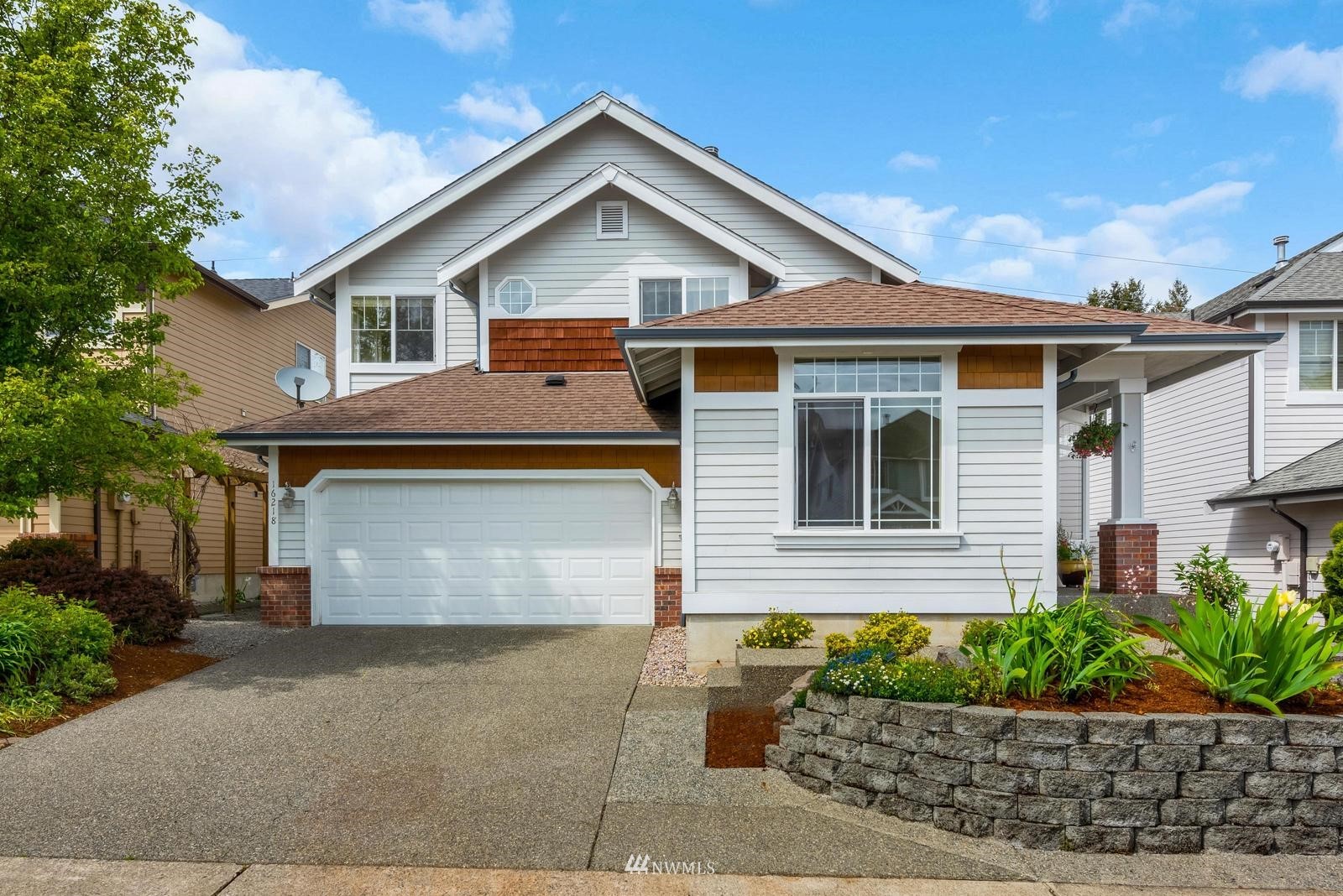 16218 Southeast 249th Place Covington, WA 98042 - Photo 36 of 38 a front view of a house with a yard and garage