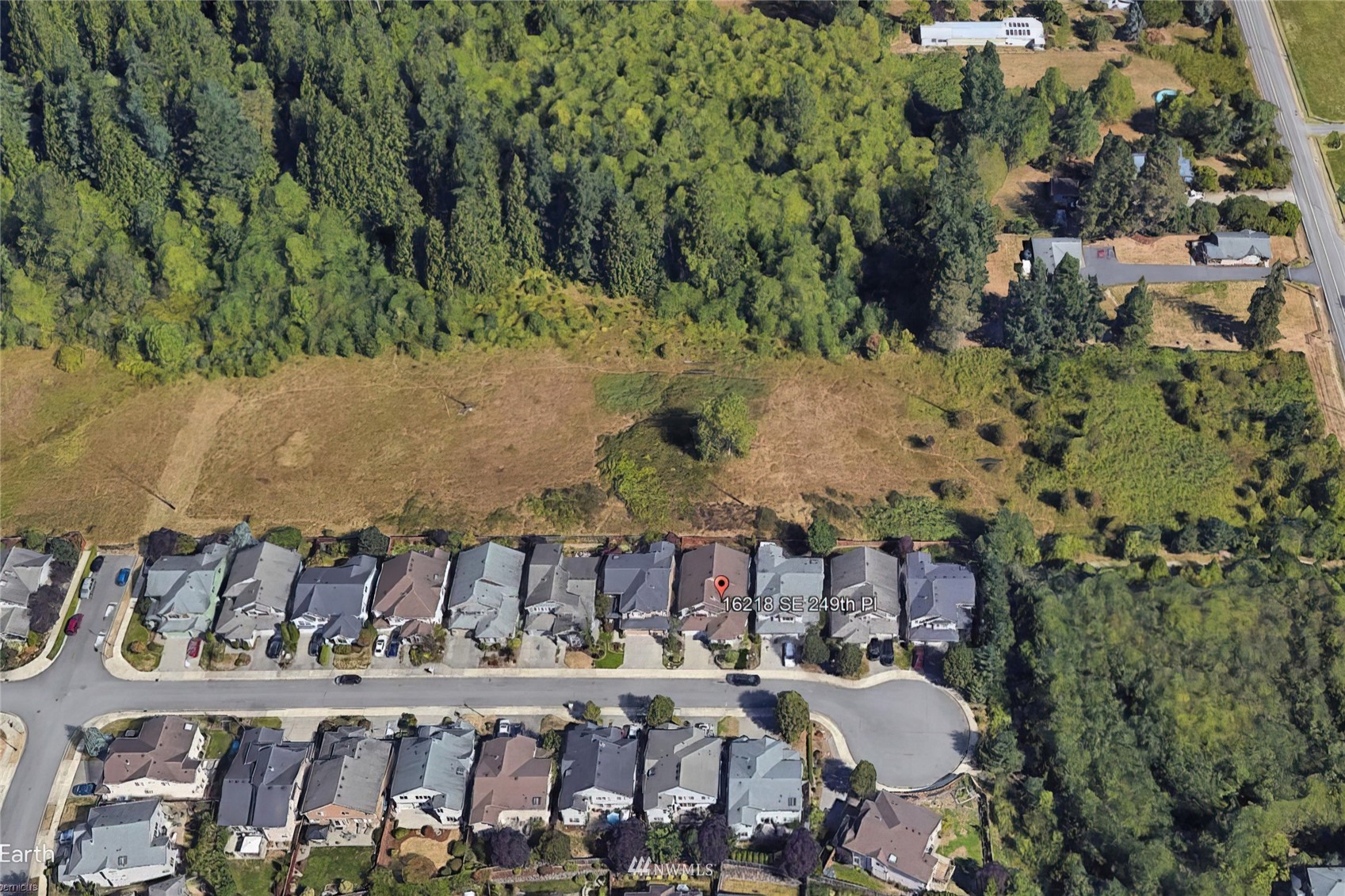 16218 Southeast 249th Place Covington, WA 98042 - Photo 38 of 38 a view of a backyard with table and chairs with wooden fence