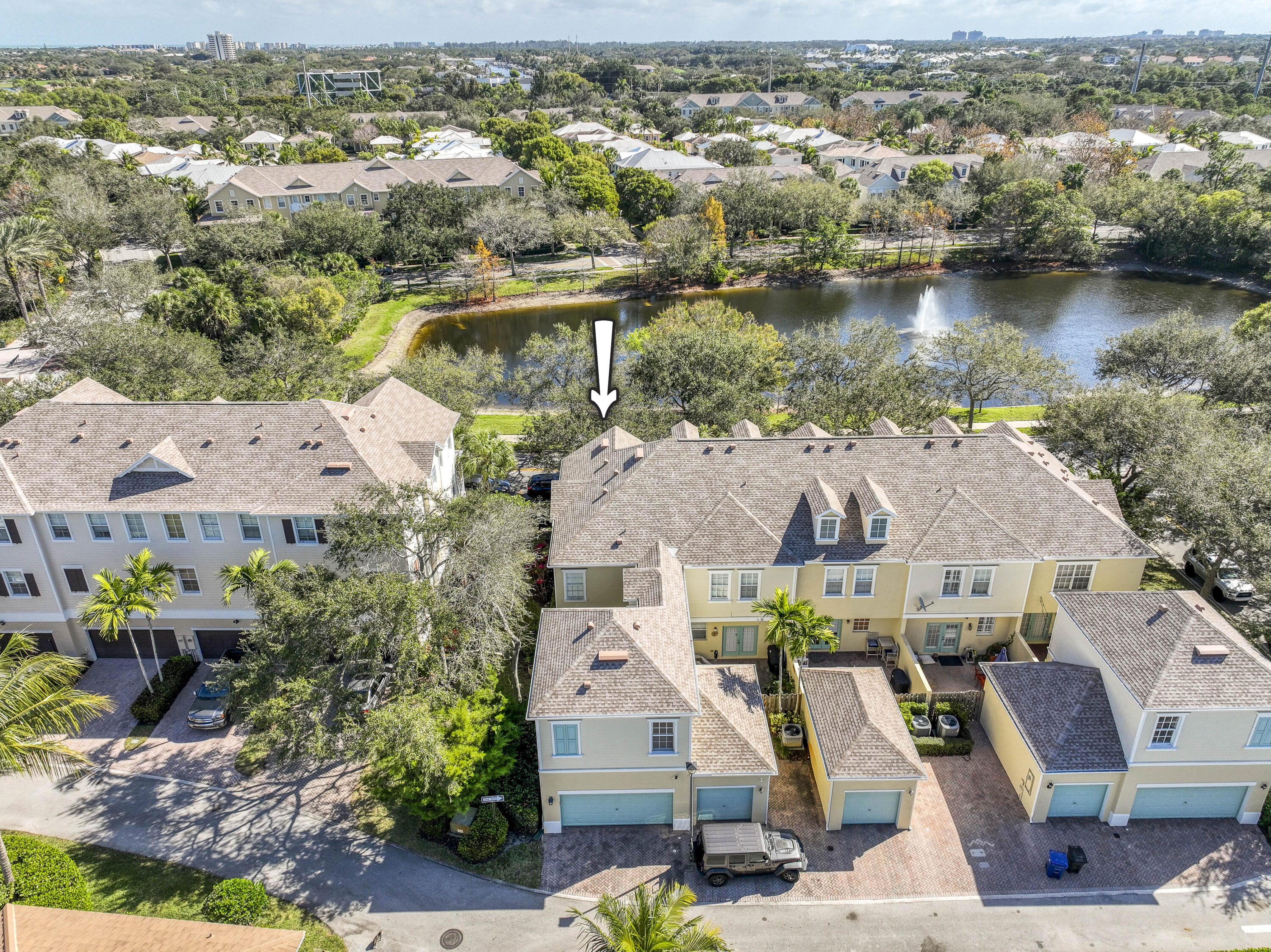 an aerial view of residential houses with outdoor space and river