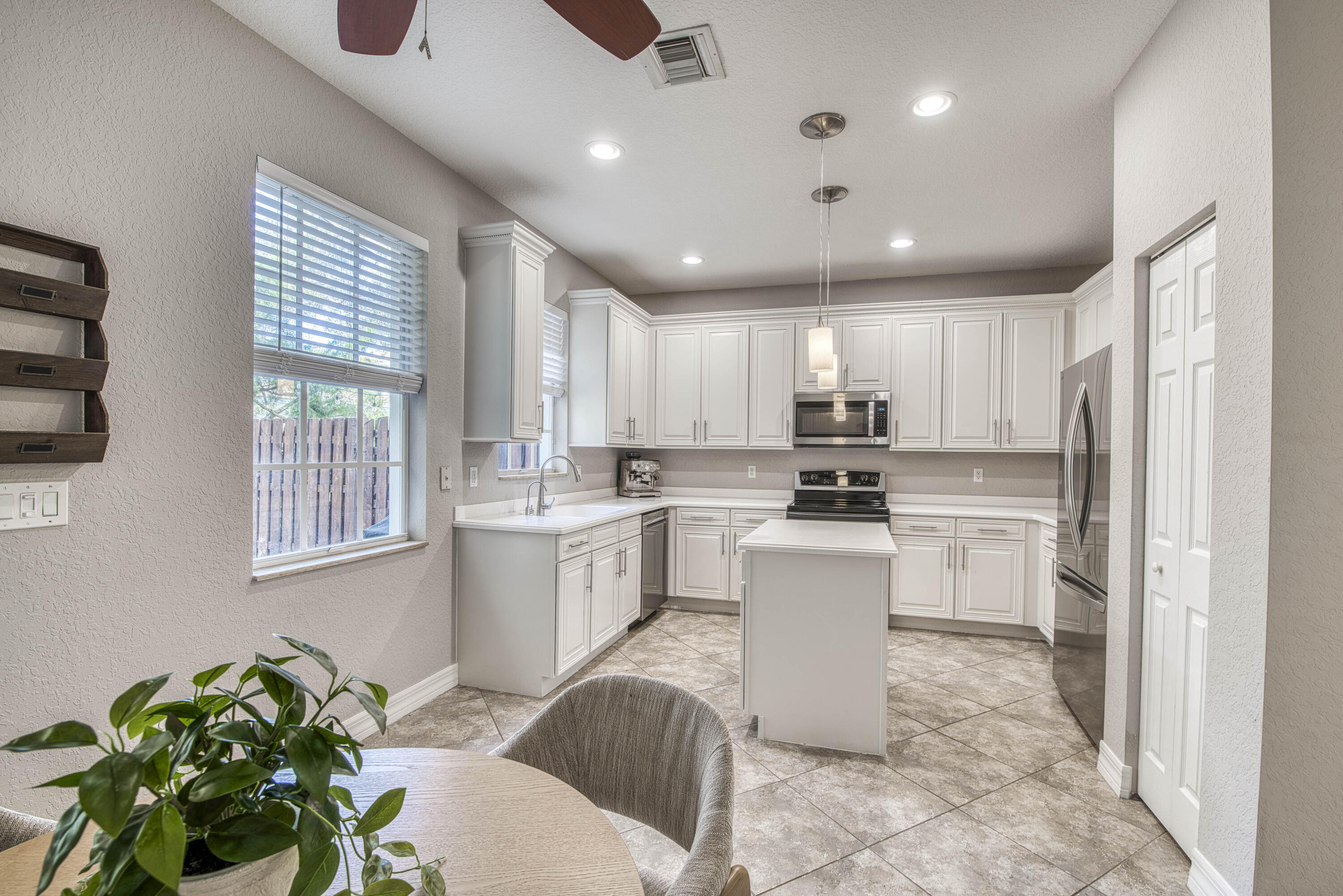 120 West Thatch Palm Circle Jupiter, FL 33458 - Photo 13 of 41 a kitchen with a sink stainless steel appliances and cabinets