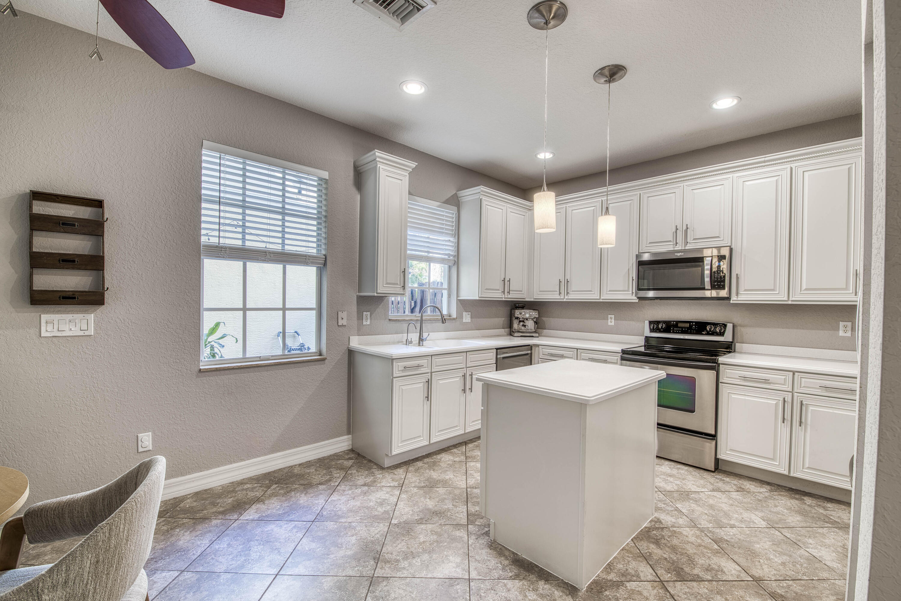 120 West Thatch Palm Circle Jupiter, FL 33458 - Photo 14 of 41 a kitchen with granite countertop cabinets stainless steel appliances and a window