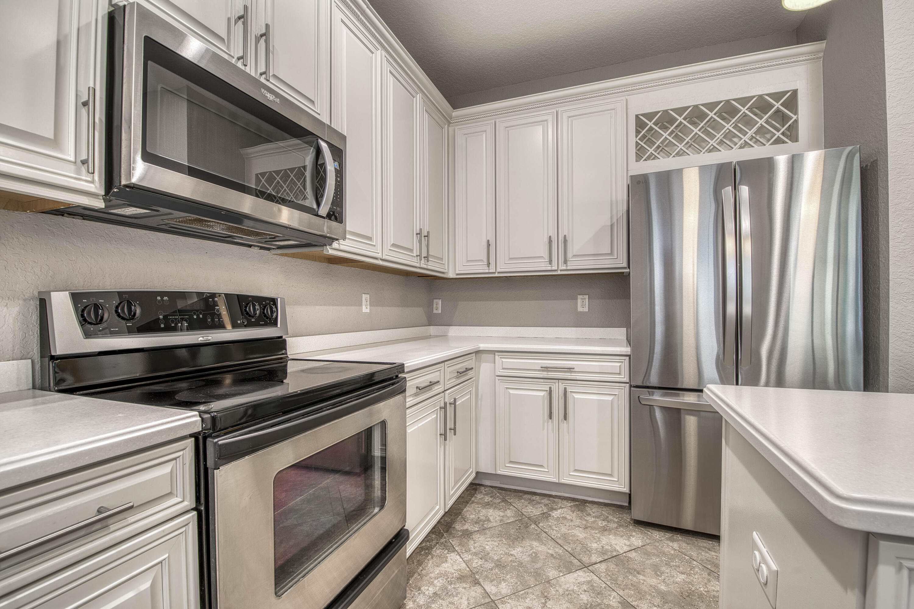 120 West Thatch Palm Circle Jupiter, FL 33458 - Photo 17 of 41 a kitchen with appliances cabinets and a stove top oven