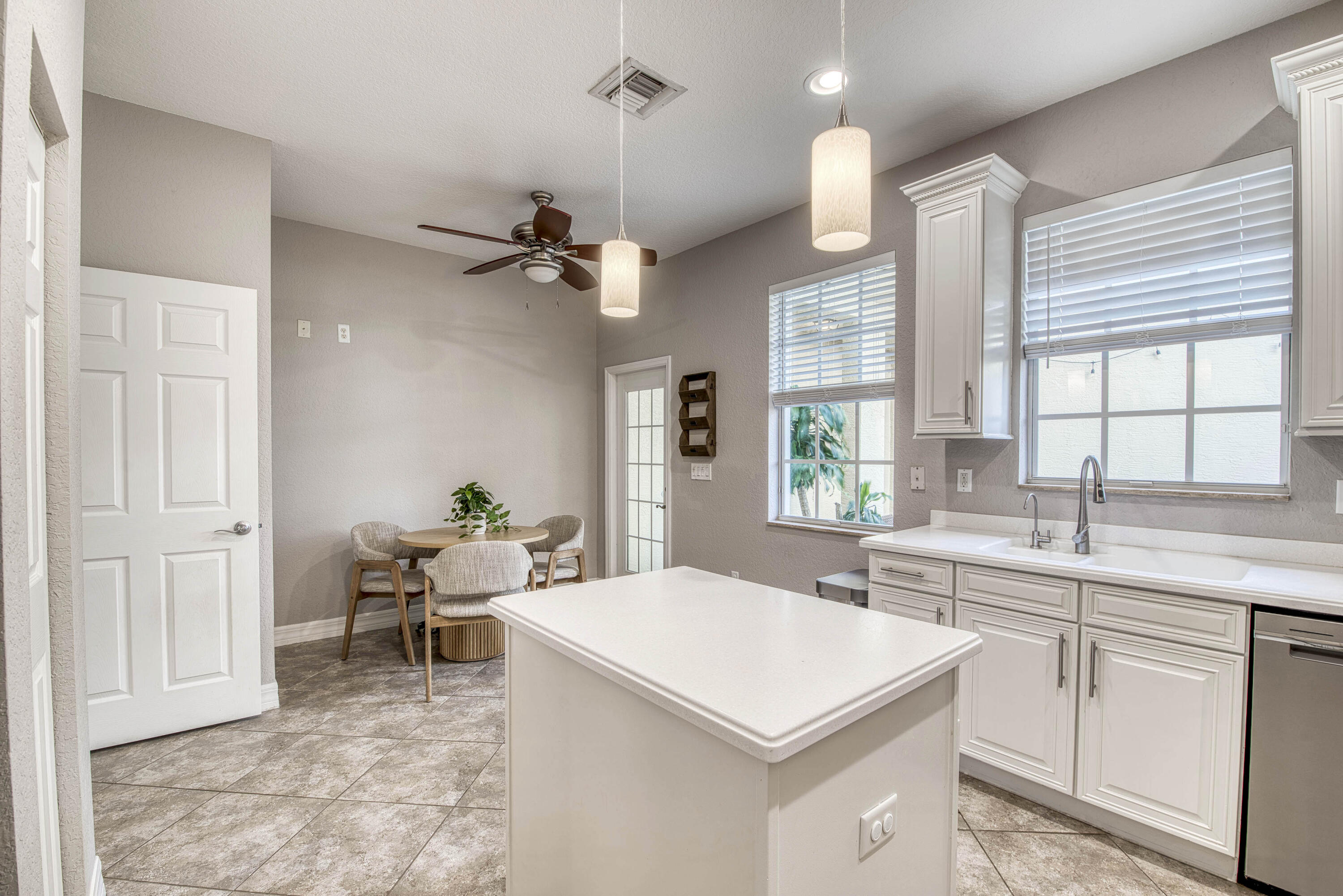 120 West Thatch Palm Circle Jupiter, FL 33458 - Photo 18 of 41 a kitchen with a table chairs sink and cabinets