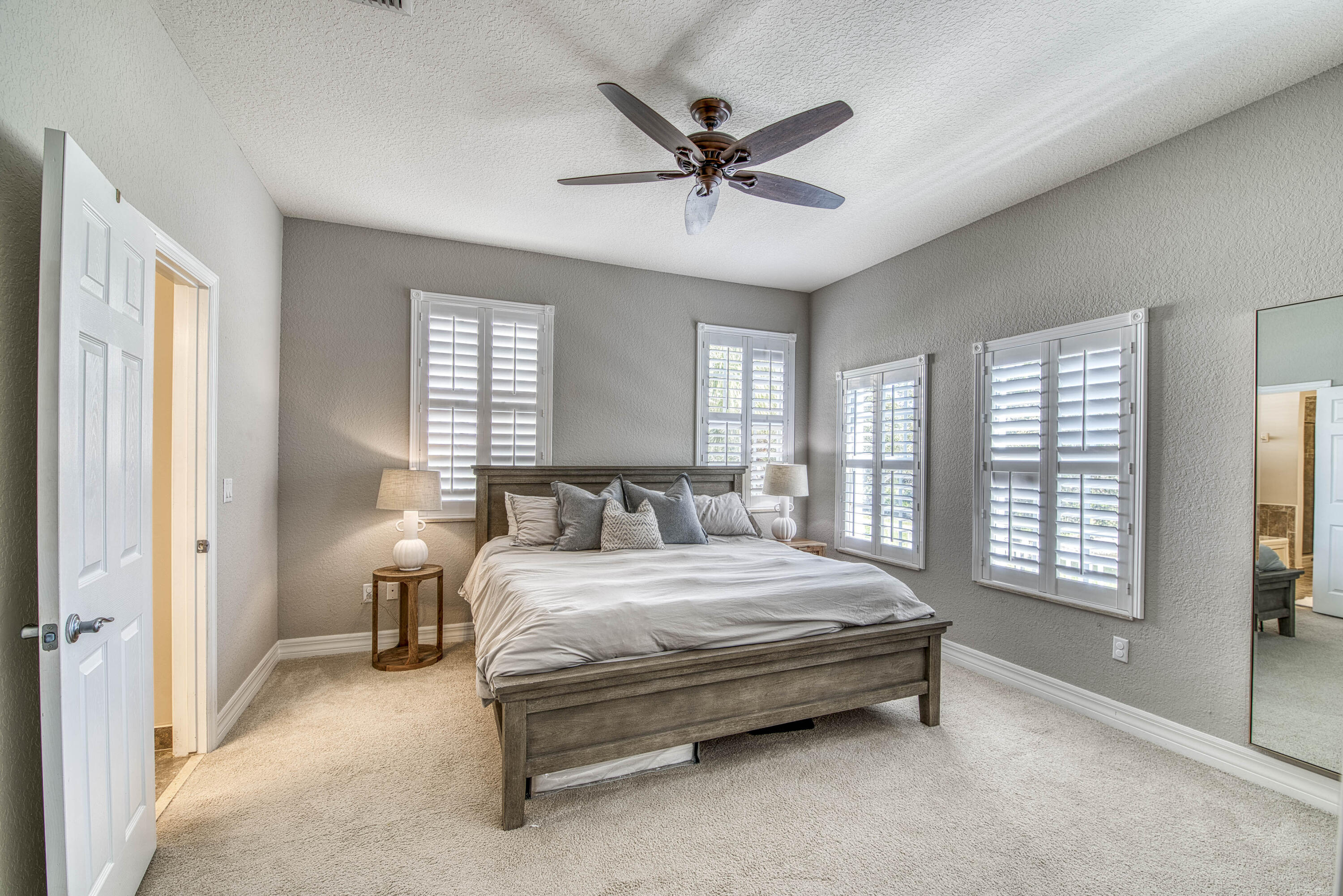 120 West Thatch Palm Circle Jupiter, FL 33458 - Photo 20 of 41 a spacious bedroom with a bed and a window