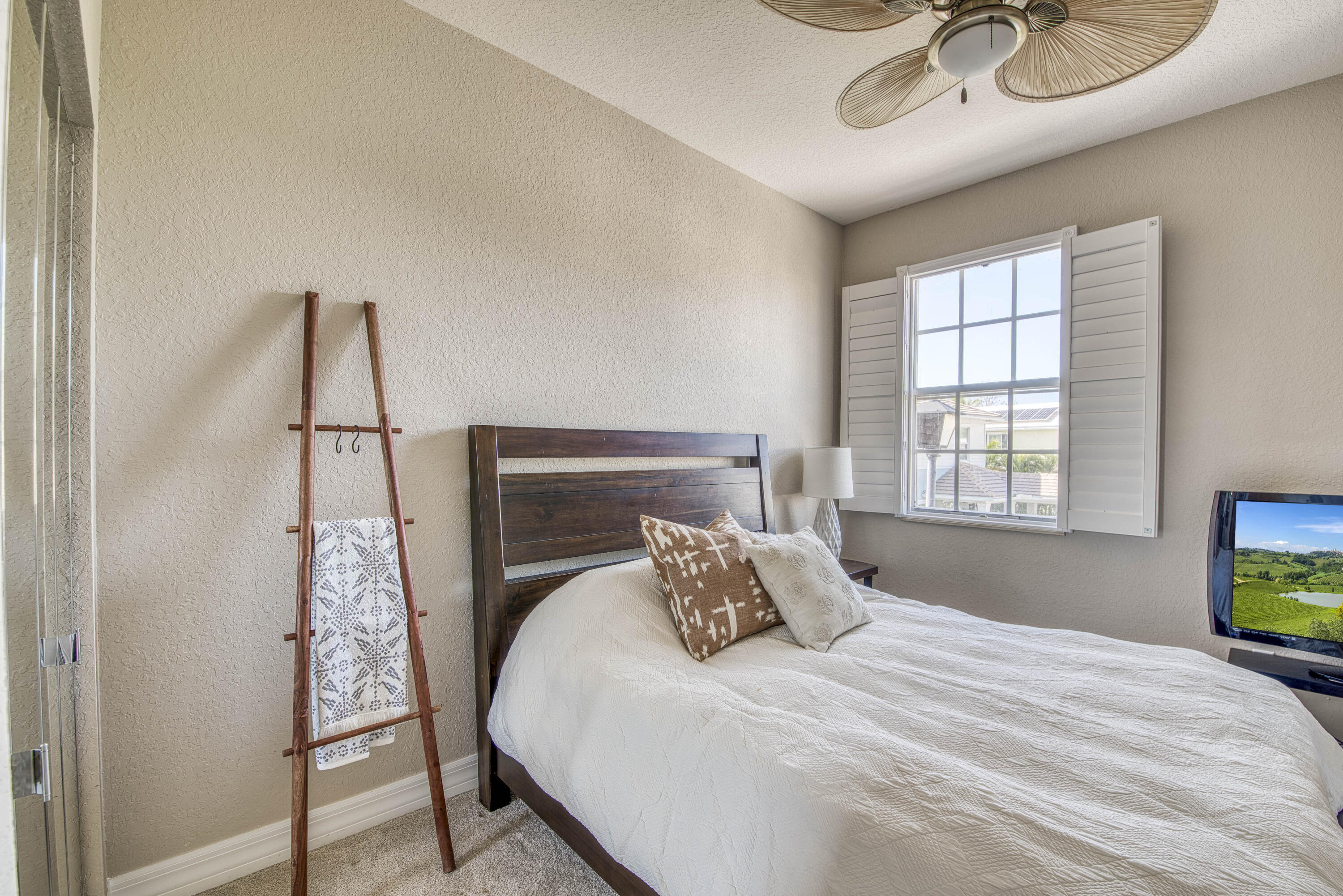 120 West Thatch Palm Circle Jupiter, FL 33458 - Photo 27 of 41 a bedroom with a bed and a window